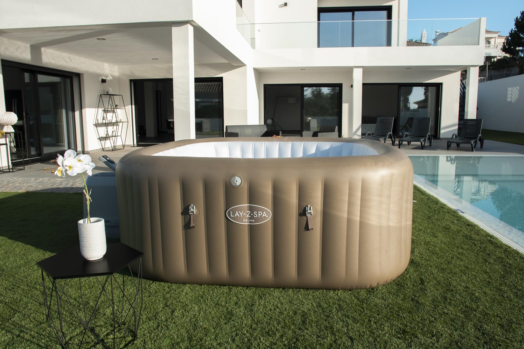 A large inflatable Palma Hydrojet Pro hot tub with seats, set up on a grassy area, ready for relaxation.